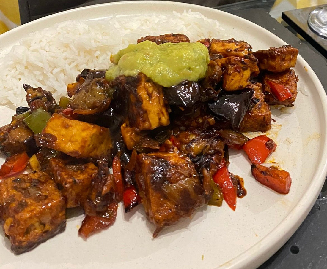 Delicious sticky chilli tofu served with rice & guacamole